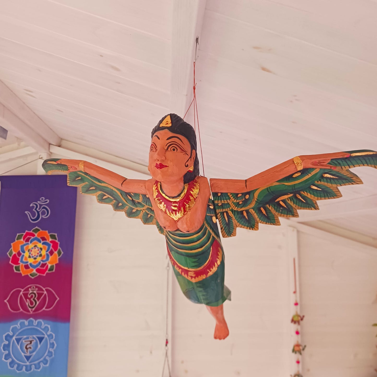 Bring a touch of the exotic to your home with this beautiful Flying Dewi Sri Lady Mobile. Hand-crafted in Bali, it features rich colours, gold detailing and a strong twine for easy hanging.