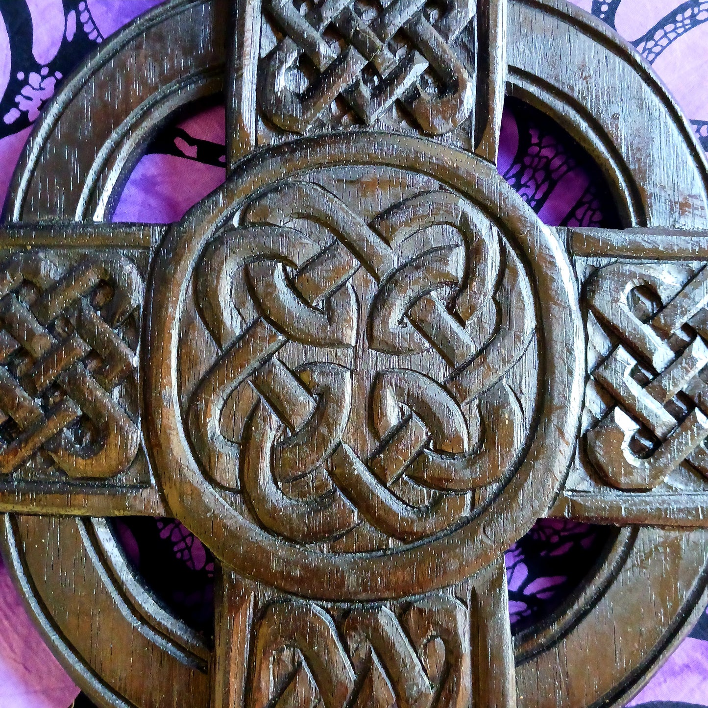 This striking cross has been hand carved in the style of a Celtic cross and features intricate interlace detailing.