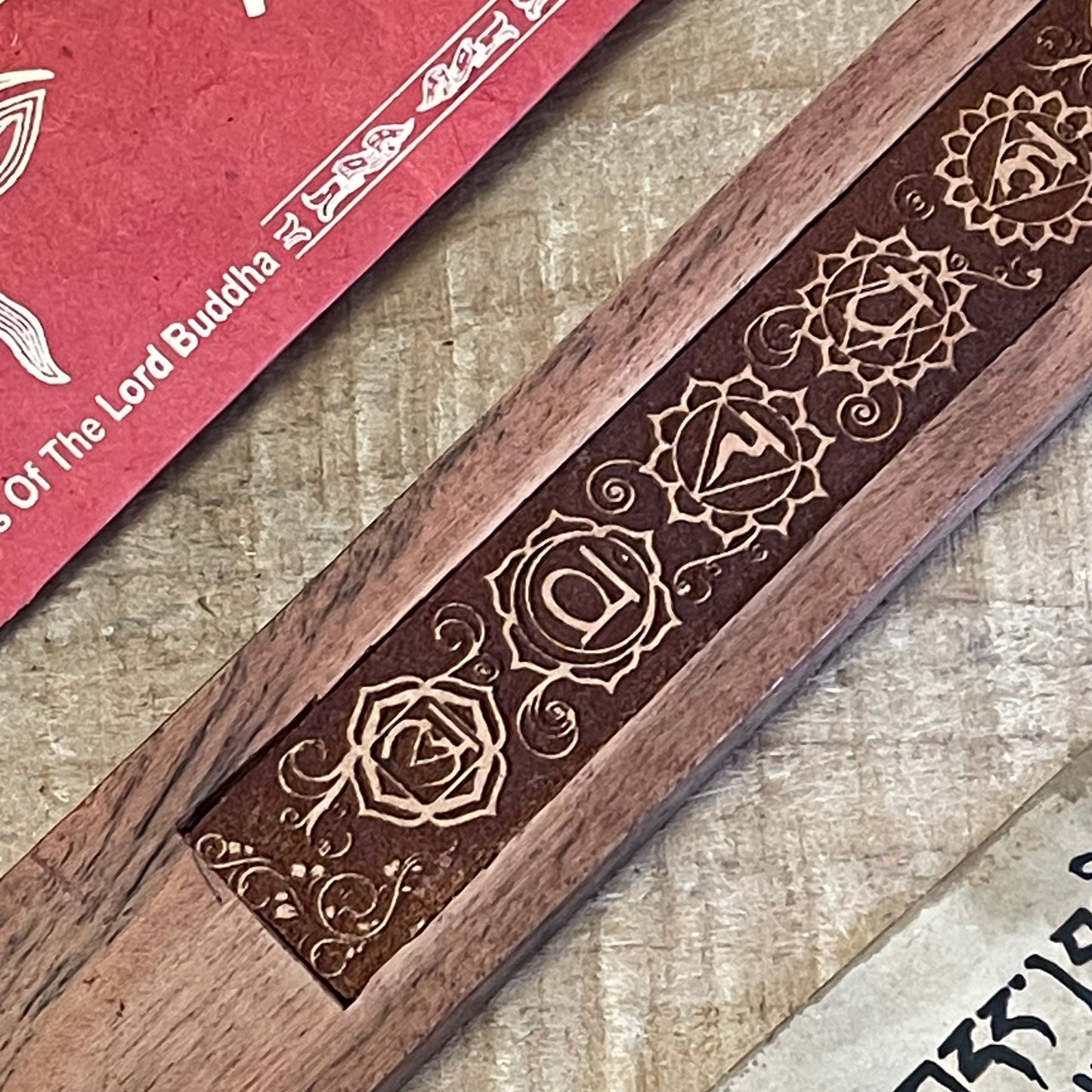 Discover our most popular incense holder: a shoe horn-style ash catcher expertly crafted from acacia wood. This elegant design features the seven Chakras, making it a beautiful addition to any space dedicated to mindfulness and meditation.