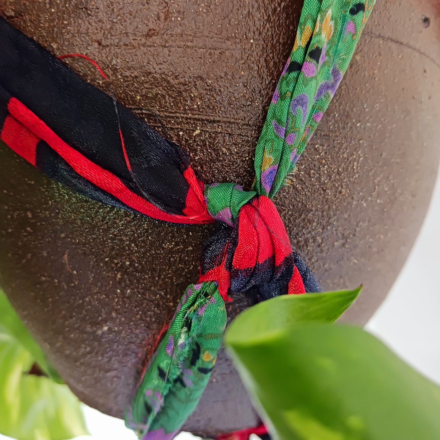 Add a burst of colour and a touch of boho charm to your home with these beautiful Large Recycled Sari Plant Hangers. Each hanger is handcrafted from upcycled sari fabric, giving new life to discarded textiles while ensuring no material goes to waste. Their simple yet elegant design allows them to complement any décor style, from minimal to eclectic. Featuring a sturdy metal ring for easy hanging, they are perfect for showcasing your favourite indoor plants in a sustainable and stylish way.
