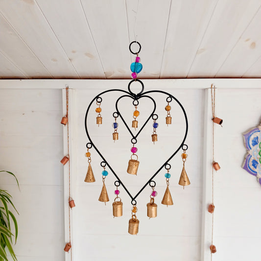 A delicate black finish windchime with two interconnected hearts surrounded by strings of multi-coloured beads and a combination of Indian brass bells. 
 Ideal for a sentimental gift and keepsake to mark a special occasion. The ideal engagement gift, to celebrate moving in together or a special anniversary.