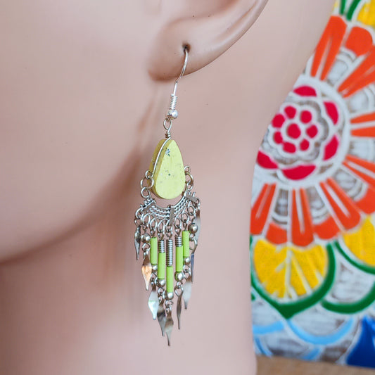 Add a touch of bohemian beauty to your look with these handmade Peruvian yellow stone and beaded earrings. Featuring a pale yellow stone paired with matching beads and finished with silver-plated hooks, each pair is carefully crafted in small workshops in Peru.