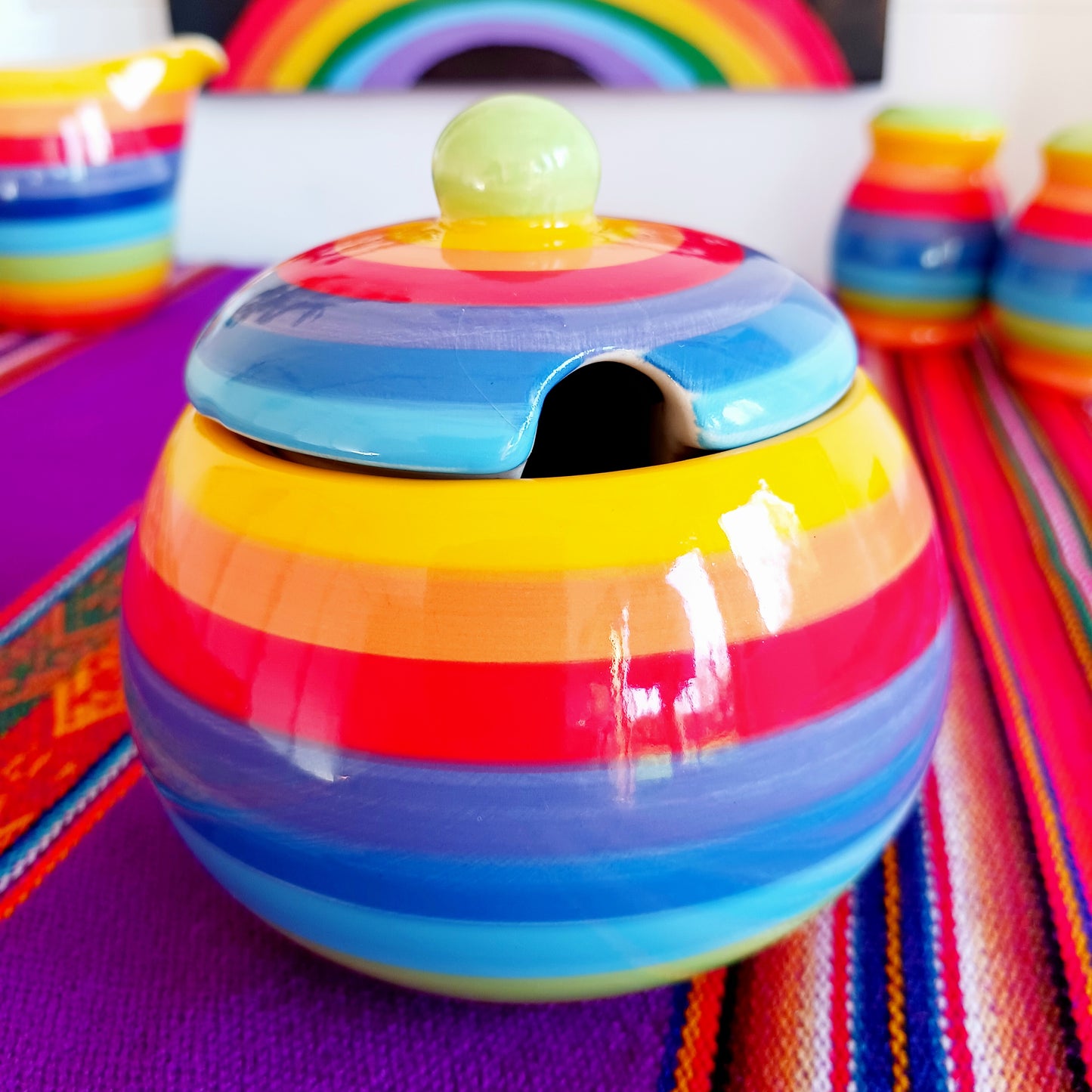 Add a splash of colour to your home with this Rainbow Stripe Ceramic Sugar Bowl. The vibrant, hand-painted stripes create a cheerful aesthetic, while the artisanal craftsmanship ensures every piece is uniquely charming. Perfect for serving sugar or small treats, this sugar bowl brightens any table setting.