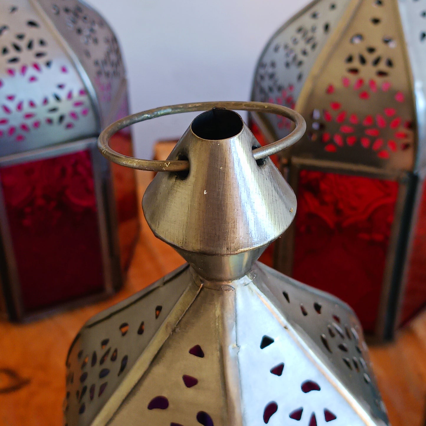 These small Moroccan style glass lanterns come in wonderful colours, featuring an intricate embossed pattern. They have a small hinged door that closes with a sliding catch. The small handle on the top is great for hanging the lanterns around your home. Perfect for adding a touch of warmth to your space.