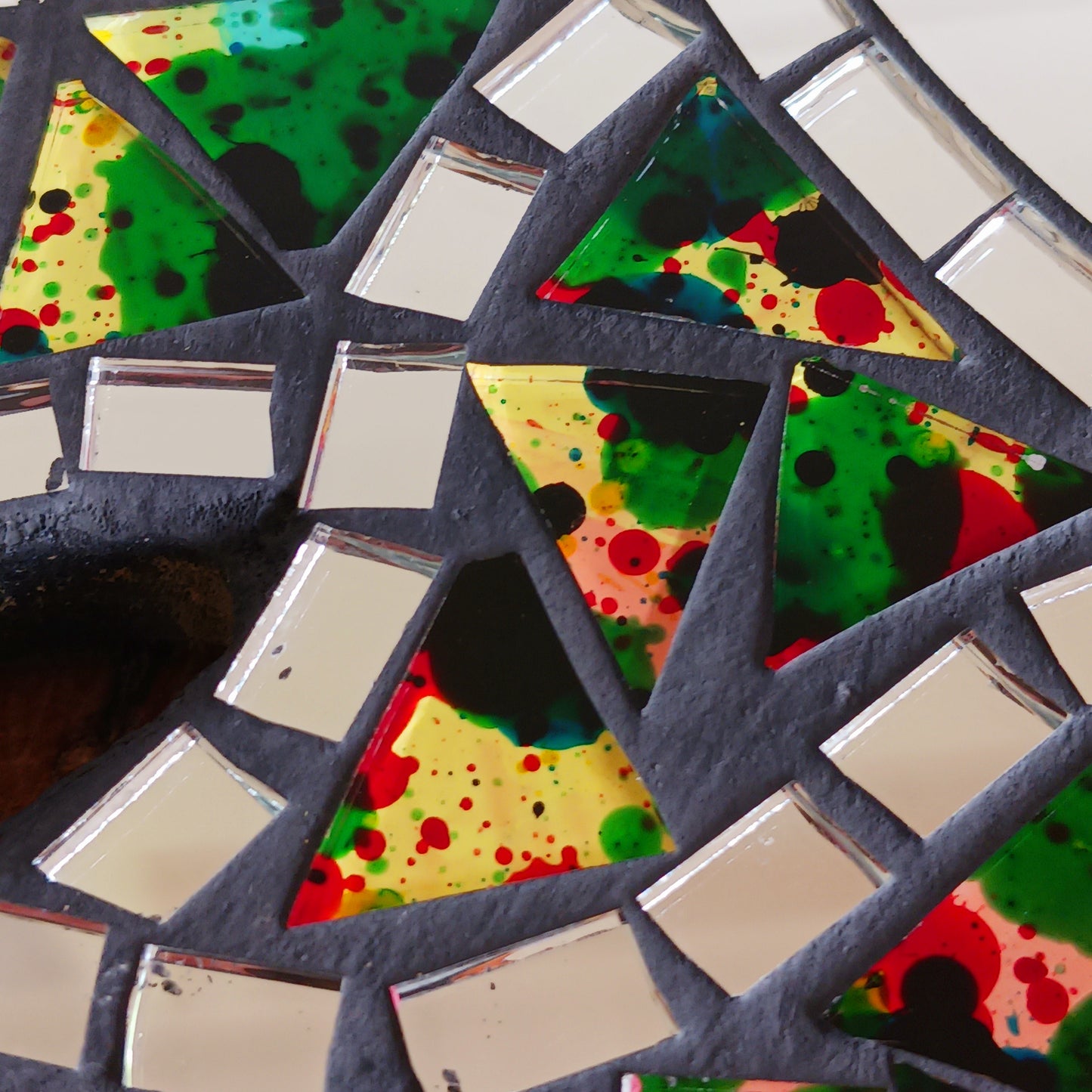 This beautiful sun shaped mirror is decoration with multicoloured glass mosaic tiles and finished on albesia wood frame.