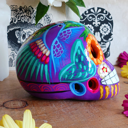 These fun ceramic sugar skull ornaments have been beautifully painted in bright colours and finished with a high shine glaze. They are a popular item during Día de Los Muertos or Day of the Dead festivities, held in Mexico every November to celebrate welcoming the souls of their deceased relatives back for a time of food, drink and celebration.