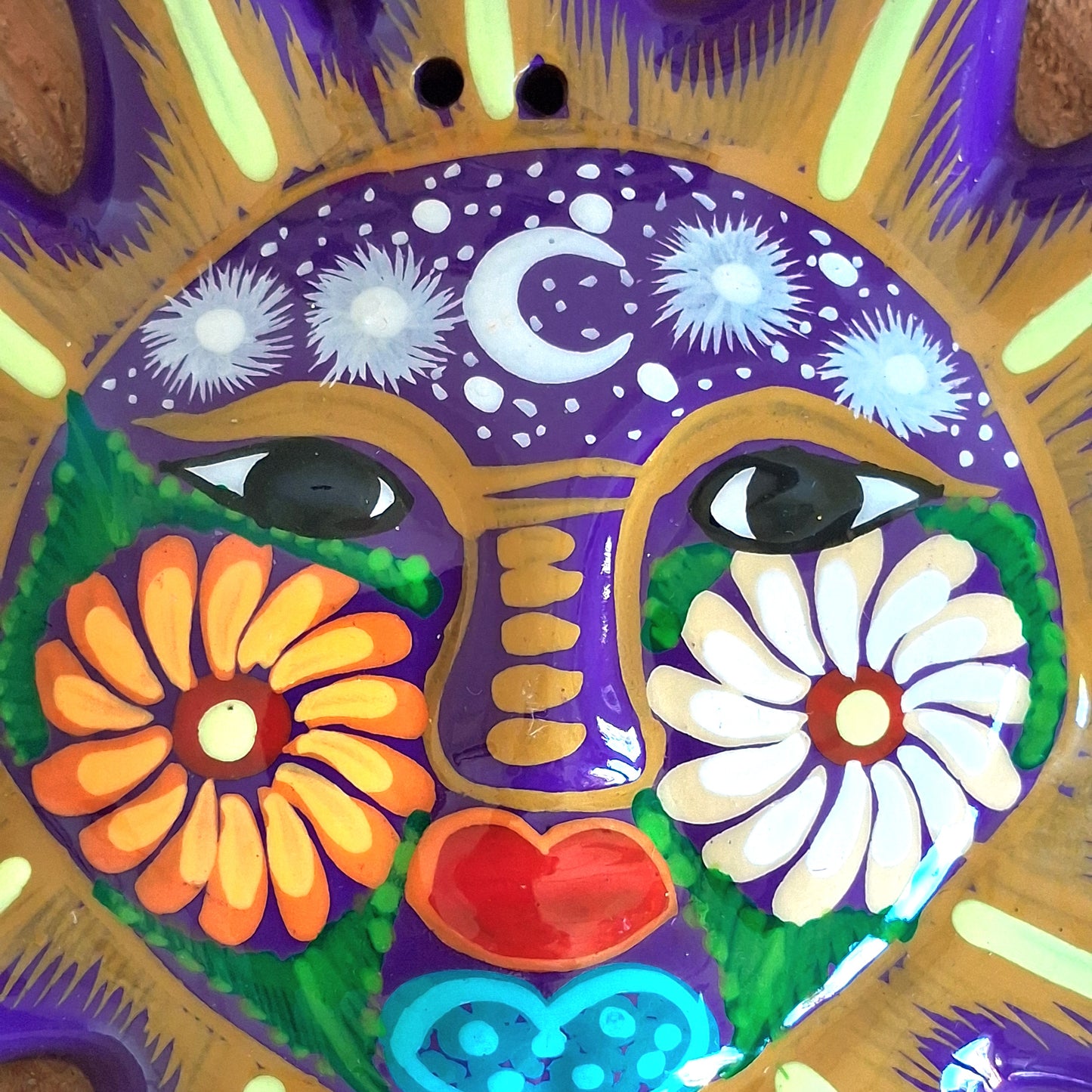 This sunny and vibrant wall plaque will get you smiling! It has been beautifully hand painted in a bright style traditional to Xalitla, a region of Guerrero, Mexico. A striking glaze adds to the bold design. It has two holes which can be used to add a hanging loop for an easy display.