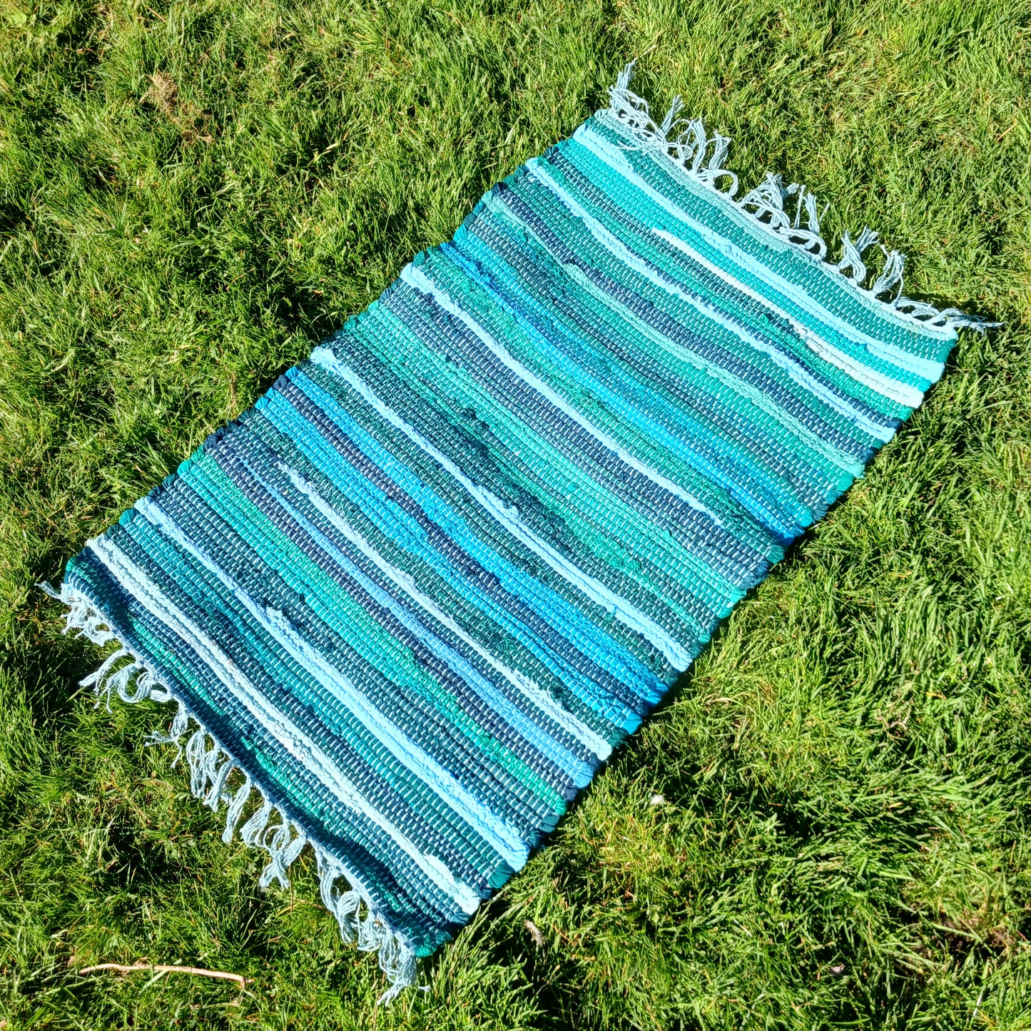 Enhance your living space with this premuim quality rag rug. Whether used in kitchens, bathrooms, or even as a decorative accent in bedrooms and living rooms, the aqua blues will bring a sense of serenity and freshness to any environment.