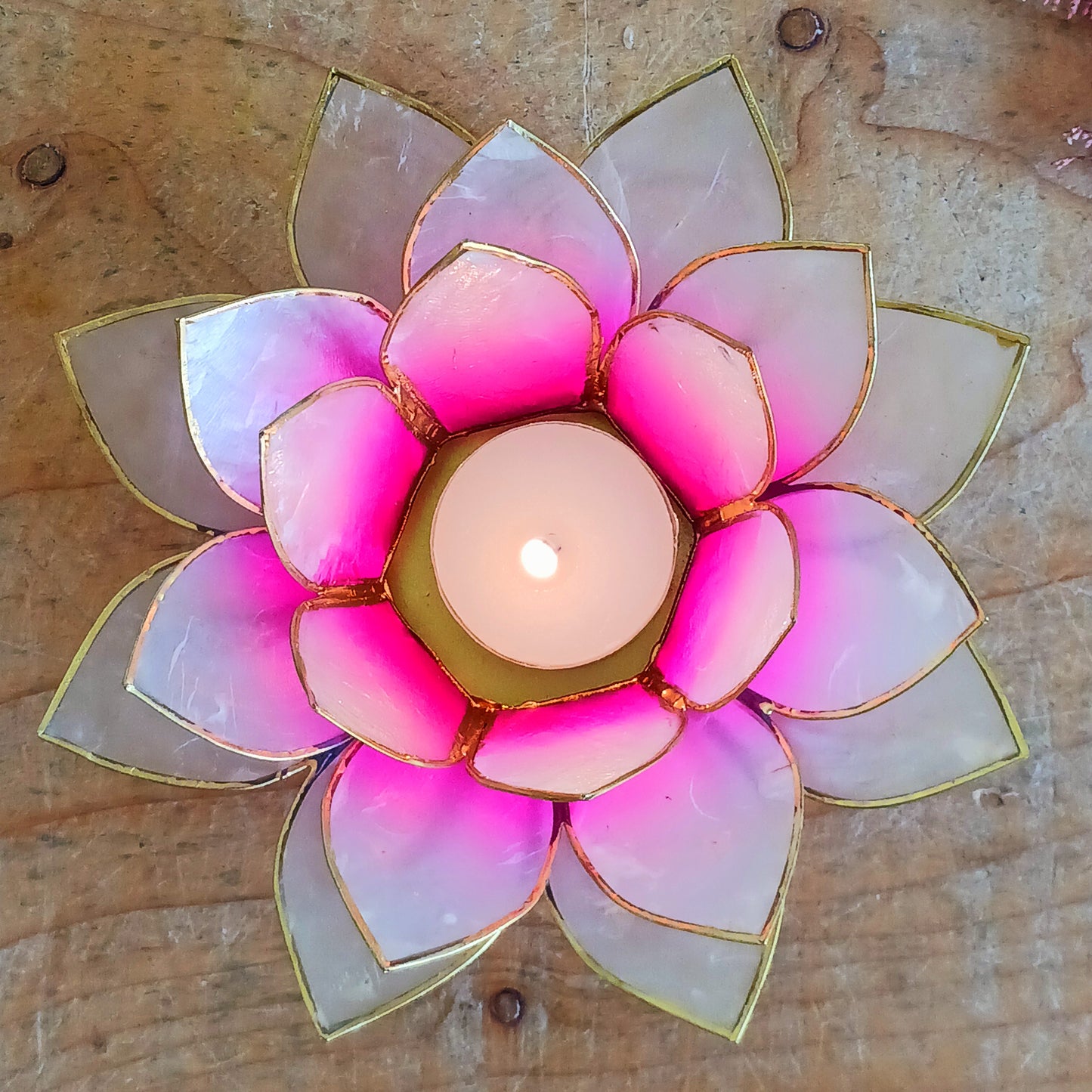 The Lotus Flower is a symbol of achieving enlightenment, peacefulness and spirituality. This beautiful candle holder can be fitted with tealight candles or slightly larger candles. The diameter of the middle is roughly 5.5cm, so it will fit any candle with the same diameter.