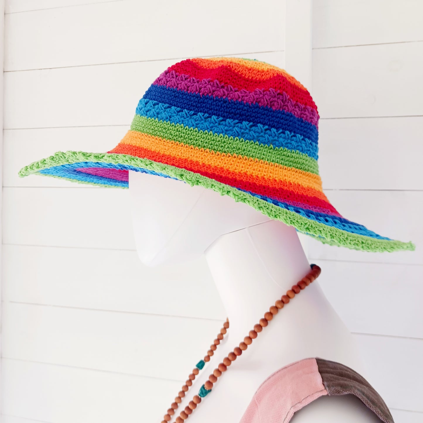 This lovely crochet cotton summer sun hat is perfect for summertime with it's vibrant rainbow colours. Each hat has a malleable wire woven into the rim to help keep the shape. Ideal for holidays and festivals.