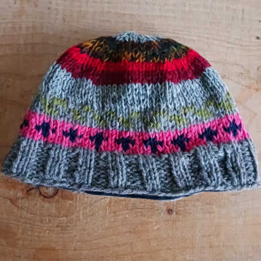 Stay warm in authentic Himalayan style with our Handmade Chunky Wool Beanie Hats, lovingly hand-knitted in Nepal by skilled Kathmandu women artisans. Crafted from 100% natural wool and lined with soft polar fleece, these beanies provide exceptional warmth, comfort, and durability — perfect for cold weather adventures or everyday winter wear.