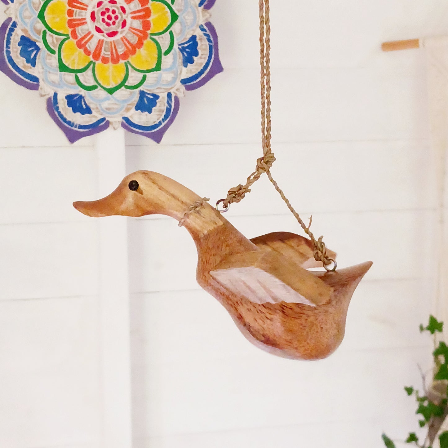 Bring a touch of whimsy and natural beauty to your home with this Handcarved Wooden Flying Duck. Each piece is meticulously crafted from solid wood, showcasing the artisan’s skill and attention to detail. The duck’s natural finish highlights the unique wood grain, adding a rustic charm that complements any interior style.