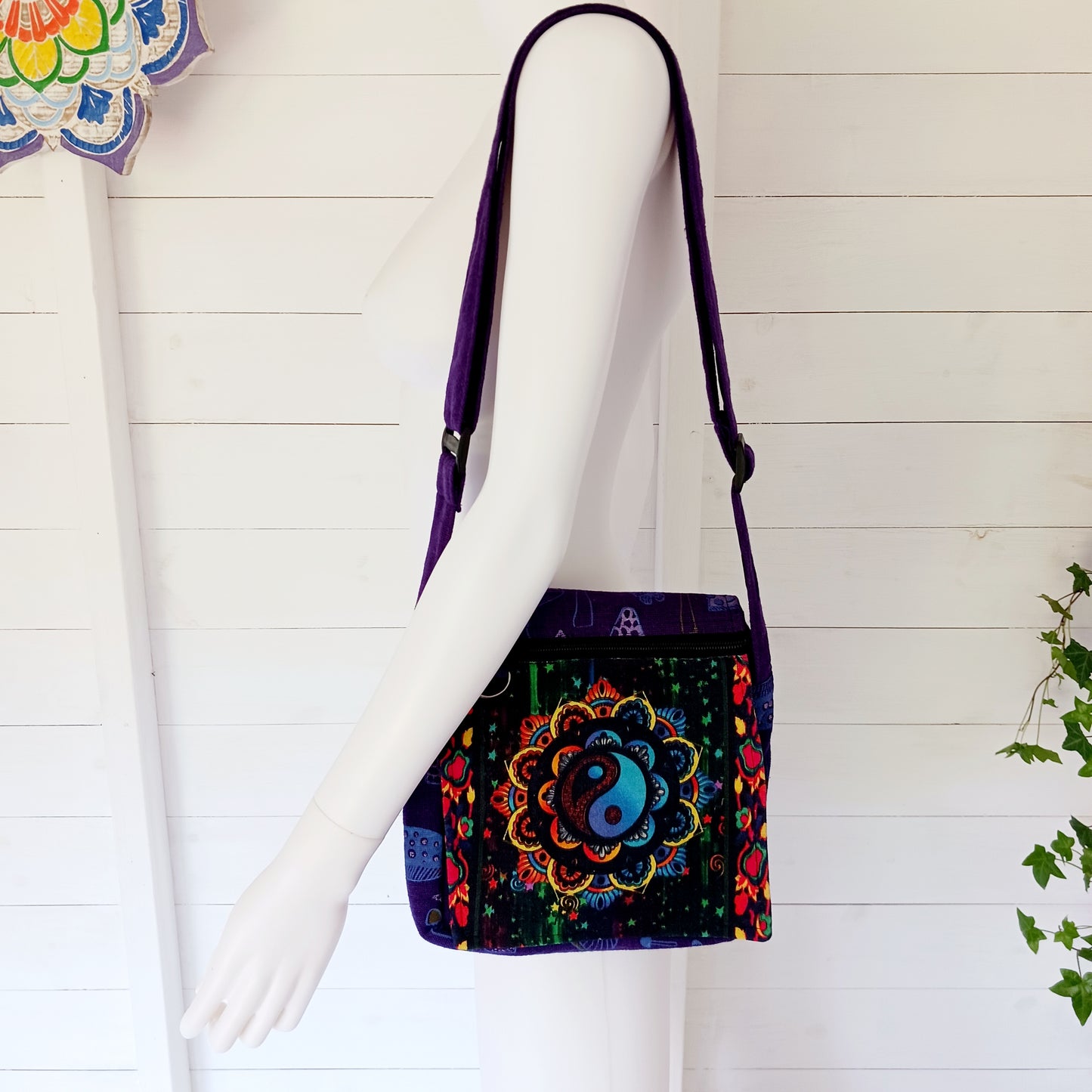This lovely Yin Yang shoulder bag is both practical and unusual. There are three zipped compartments ensuring you keep your valuables safe. The Yin Yang design on the front is set in a colourful mandala on the flap, and this is secured with a velcro strips. The staps are adjustable to suit your style.