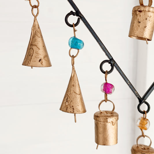 A delicate black finish windchime with two interconnected hearts surrounded by strings of multi-coloured beads and a combination of Indian brass bells. 
 Ideal for a sentimental gift and keepsake to mark a special occasion. The ideal engagement gift, to celebrate moving in together or a special anniversary.