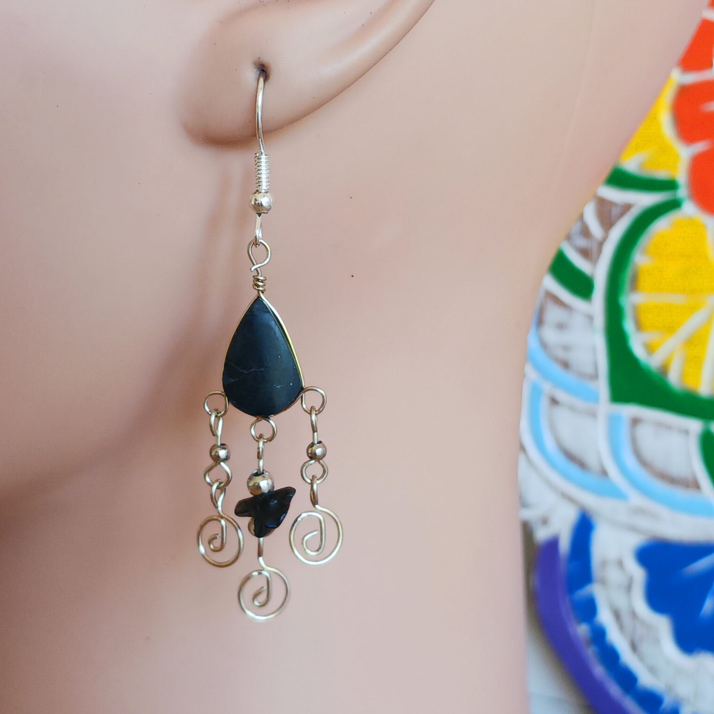 These beautiful spiral earrings feature a turquoise stone and three spirals. They dangle really nicely when worn, and are easy to dress up or down. The hooks are made from sterling silver.