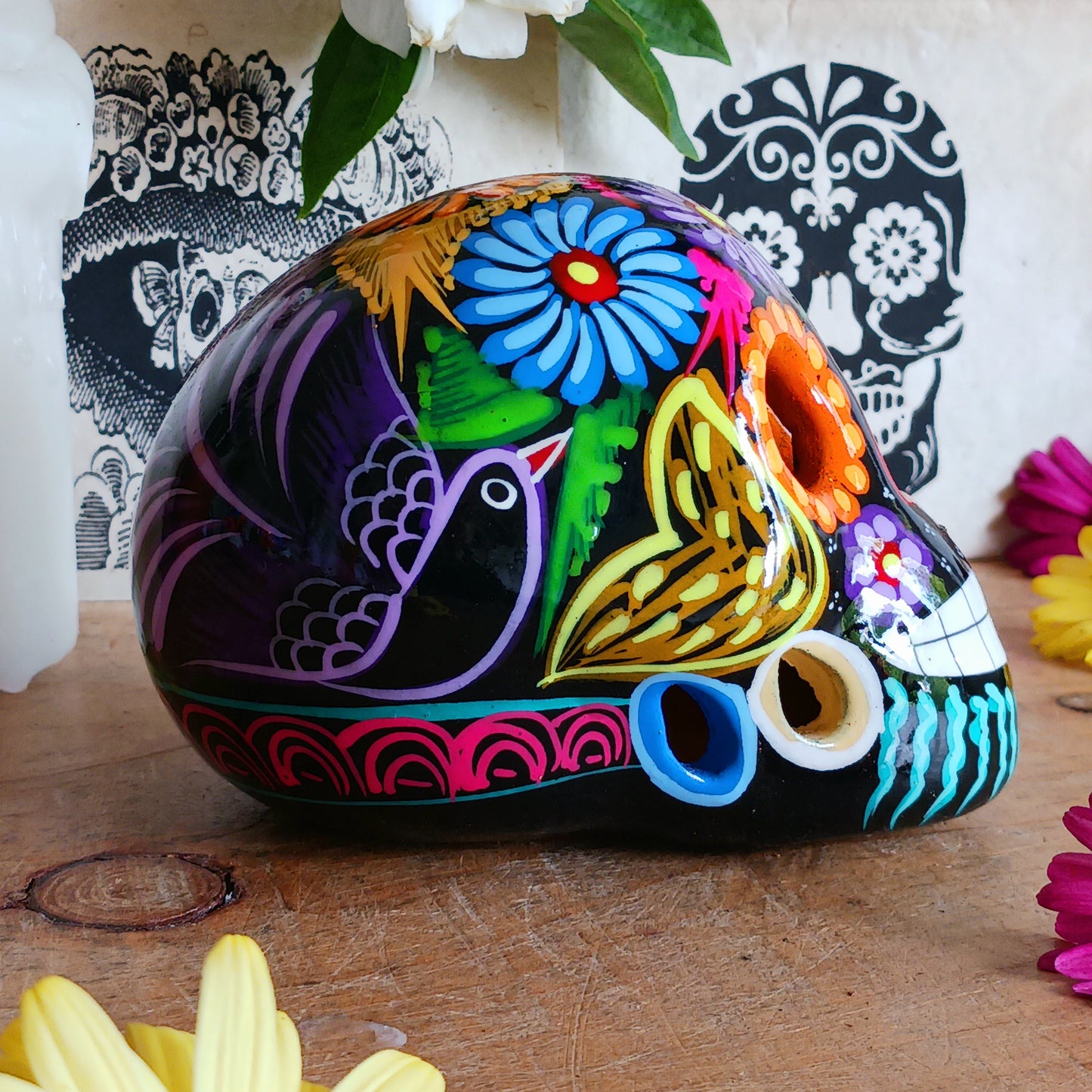 These fun ceramic sugar skull ornaments have been beautifully painted in bright colours and finished with a high shine glaze. They are a popular item during Día de Los Muertos or Day of the Dead festivities, held in Mexico every November to celebrate welcoming the souls of their deceased relatives back for a time of food, drink and celebration.