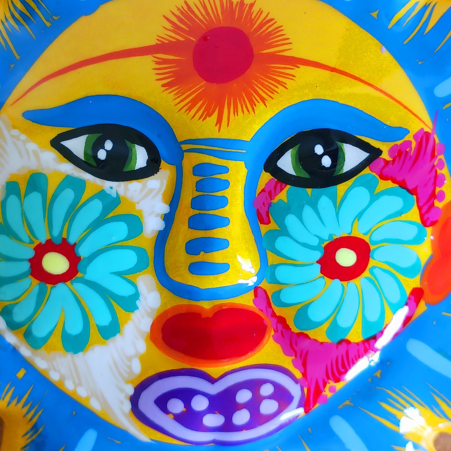 Bring a burst of colour and joy into your space with this sunny, vibrant wall plaque! Expertly hand-painted in the bold, traditional style of Xalitla, Guerrero, Mexico, this decorative piece radiates cultural charm. The vivid colors and striking glaze add depth and personality, making it a standout feature in any room. With two convenient holes for easy hanging, it’s ready to brighten your home with authentic folk art flair.