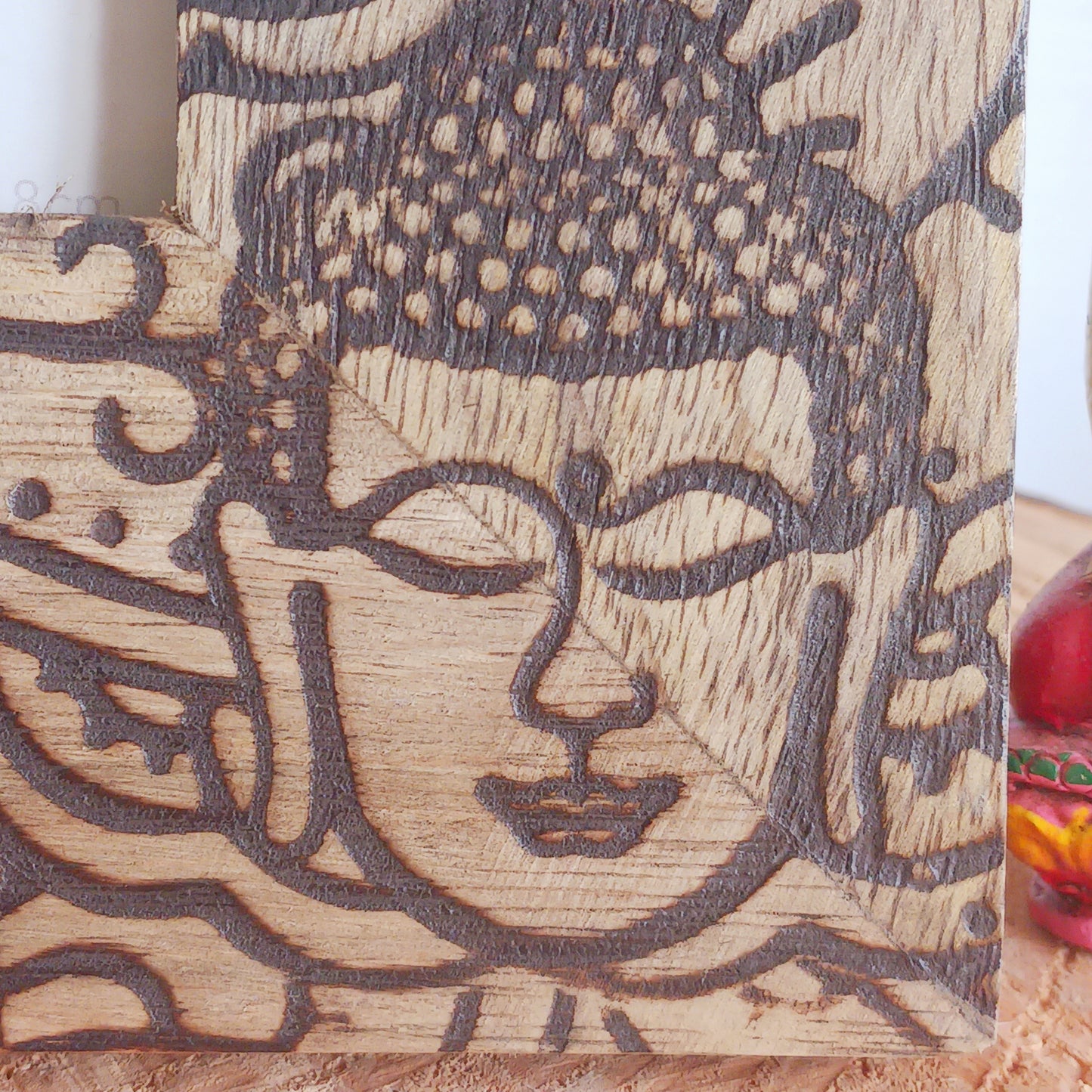 Made in India from sustainably sourced mango wood, these lovely picture frames bring warmth, character, and meaning to any space. Each one is carefully carved or painted with spiritual and cultural designs that go beyond decoration holding deep symbolism and tradition. The small Buddha in the corner is a peaceful presence that represents wisdom and enlightenment. Ideal for meditation spaces, yoga studios, or anyone seeking a sense of calm.