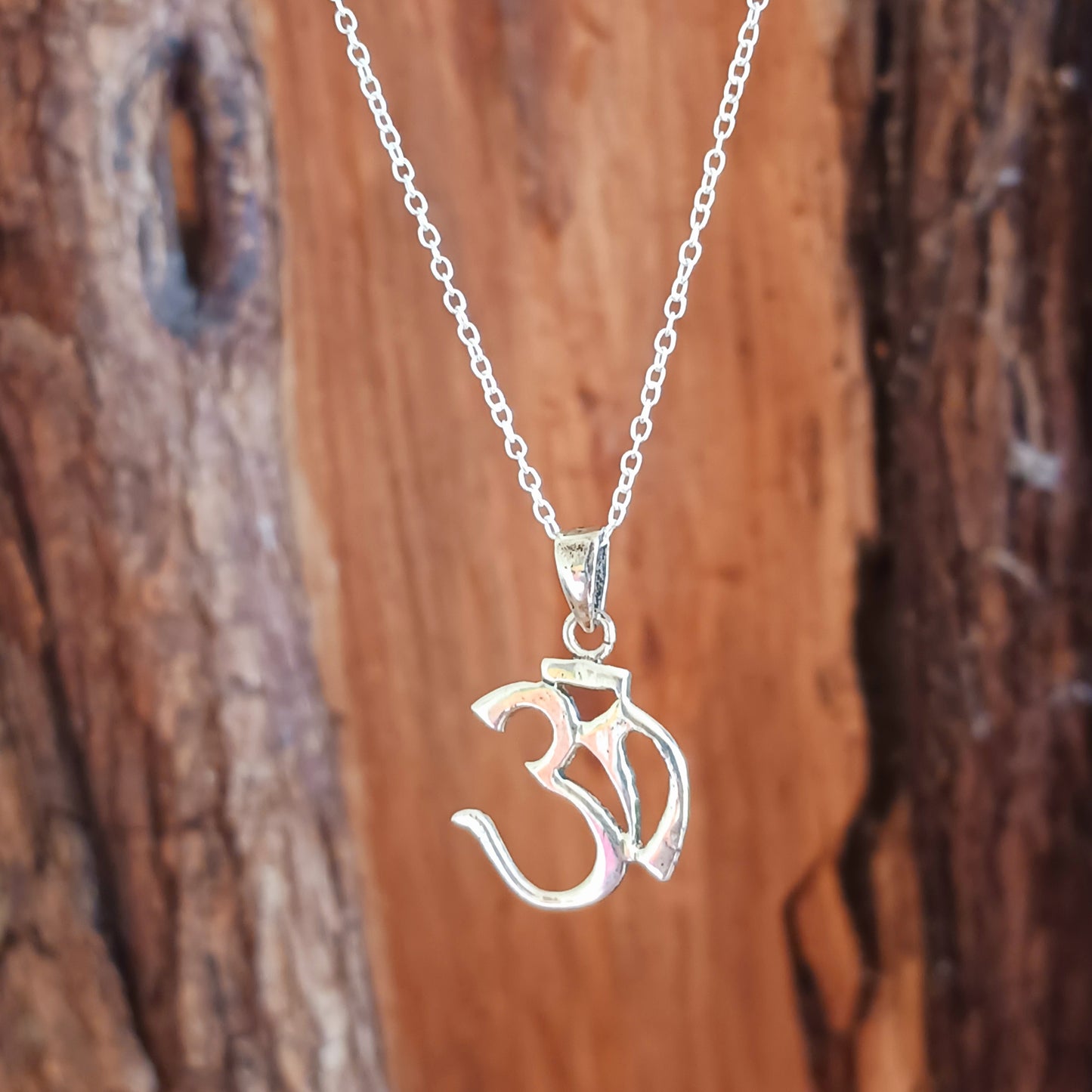This classic sterling silver Om pendant on a sterling silver chain is intended to calm the mind and bring spiritual knowledge and insight. Handcrafted for durability and designed to last a lifetime.