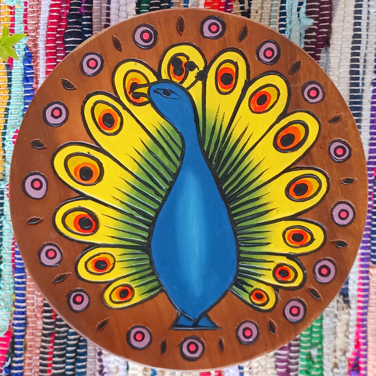 This lovely handmade, carved and painted stool is Fairtrade from Thailand. The top of this stool has been carefully hand carved and then painted to show a radiantly beautiful peacock, displaying his wonderful plumage. These cheeky little items are very versatile making great stools for little bums or as tiny tables to add accent to your home.