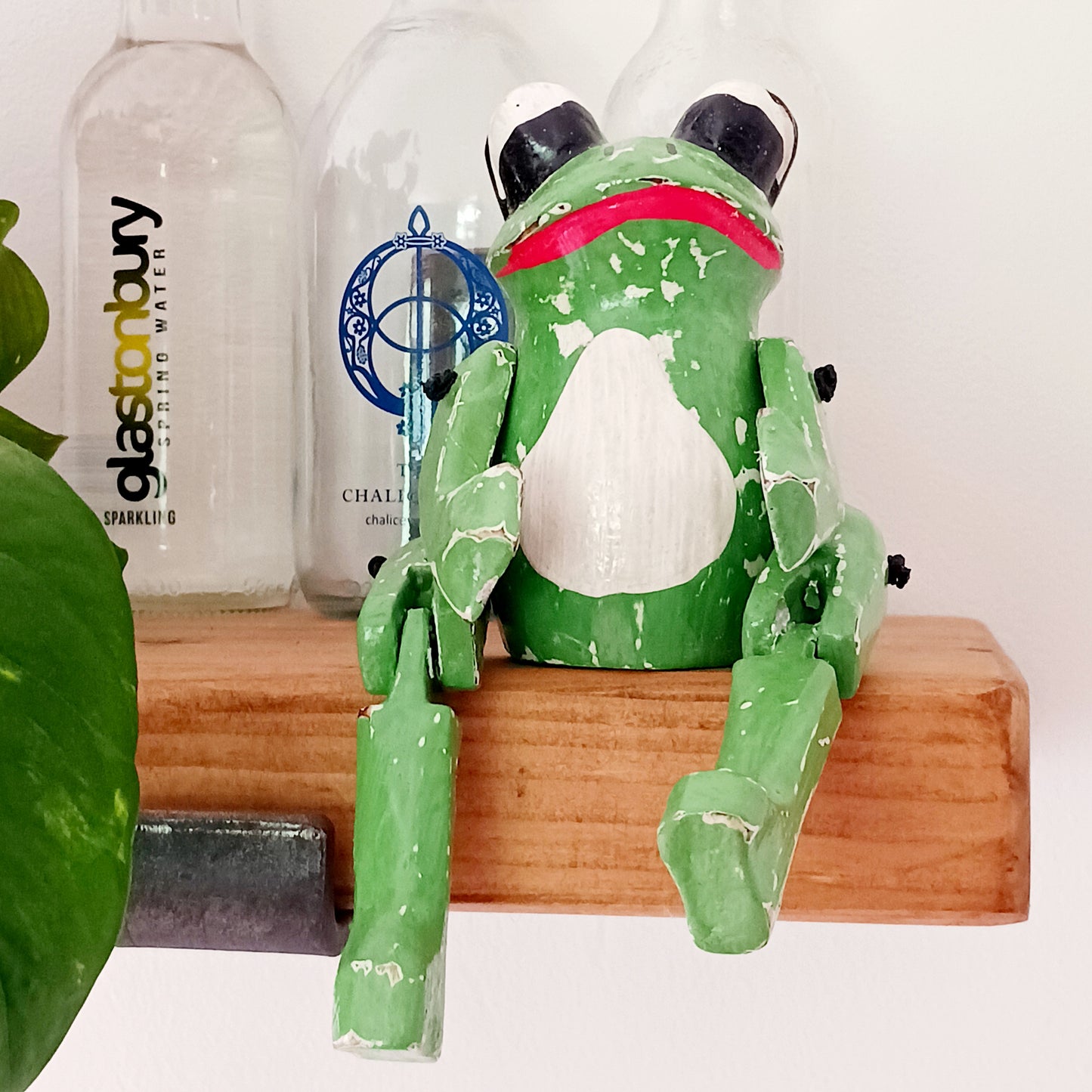Add a playful touch of nature-inspired charm to your home with our Charming Green Sitting Frog Shelf Sitter Ornament. Featuring a vibrant green finish and an irresistibly sweet expression, this adorable frog is designed to bring joy and personality to any room.