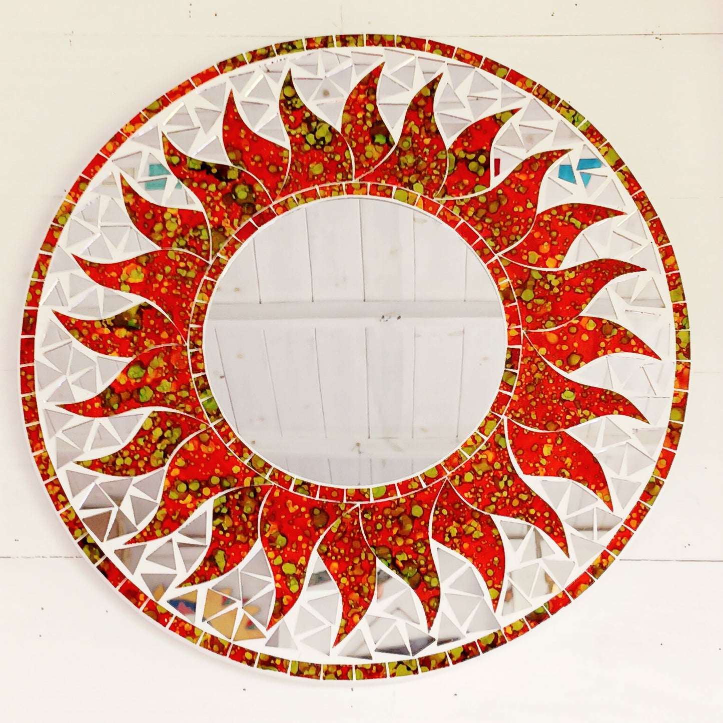 dd warmth, energy, and artistic charm to your home with this beautiful Vibrant Orange Mosaic Sun Mirror. Designed with dazzling orange mosaic tiles arranged in a radiant sunburst pattern, this captivating wall accent instantly brightens any room.