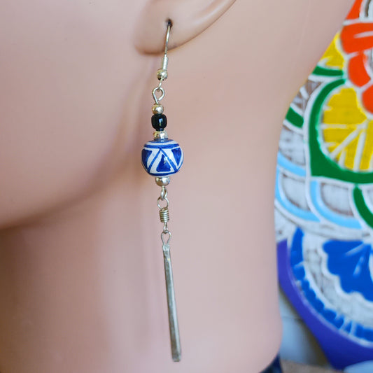 These pretty and stylish blue and white earrings have been handmade from clay beads from Cusco, Peru. Each earring features a unique hand-painted pattern that will remind of summer.