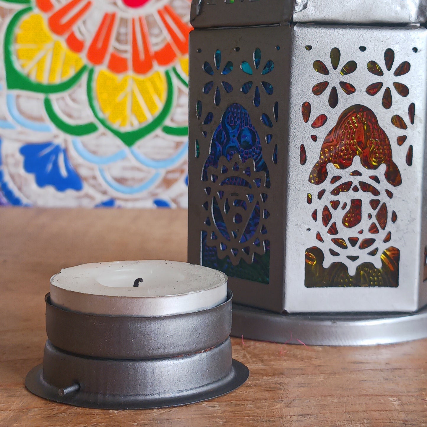 This delightful little seven-sided standing lantern has each side elegantly showcasing a chakra symbol. With a convenient bottom-opening door that doubles as a candle holder tray, this lantern is practical and attractive.