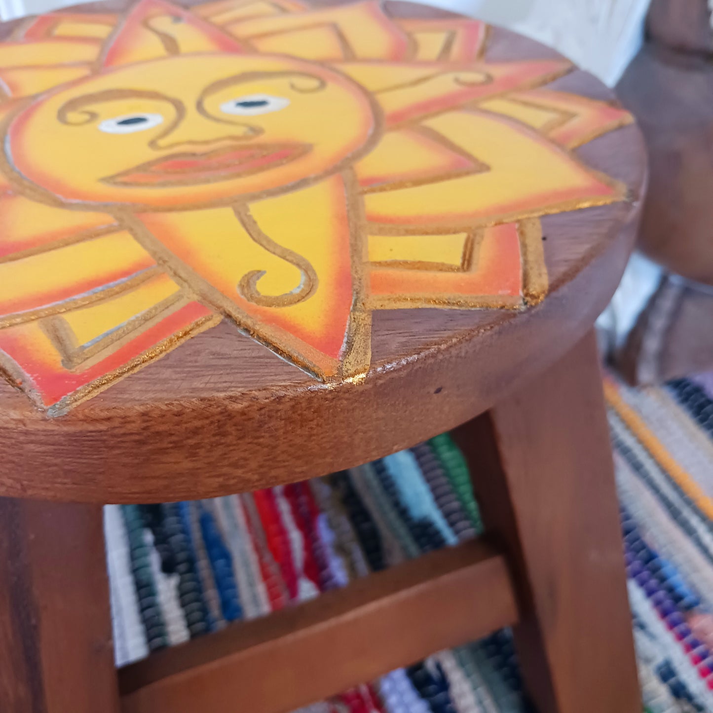 This lovely little handmade, carved and painted stool is Fairtrade from Thailand. It features a vibrant, radiant sun carving with beautiful gold detailing. These cheeky little items are very versatile making great stools for little bums or as tiny tables to add accent to your home. They can also be very useful as a step for those hard to reach high up shelves or even just to put your feet up on, and due to their small form are easy to store.
