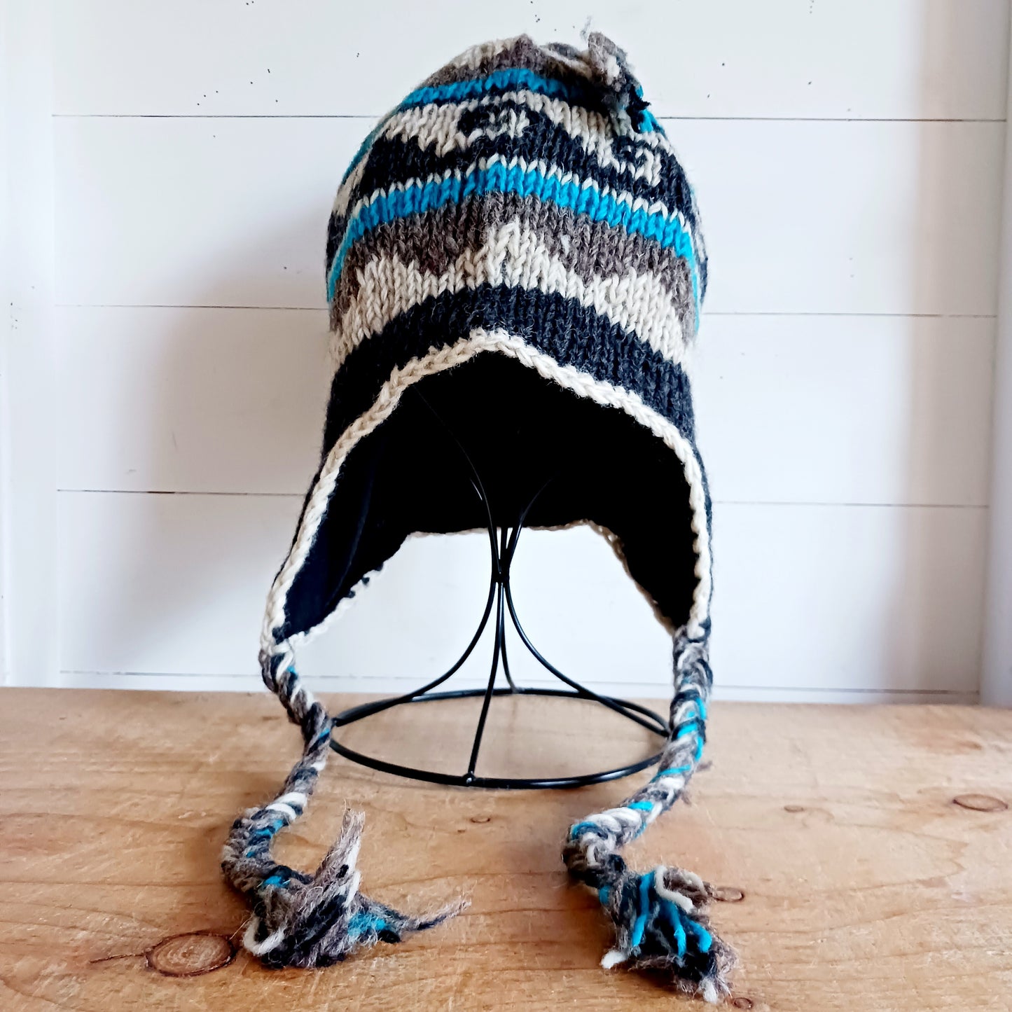 Stay cozy and stylish with our handmade chunky wool earflap hats, crafted in Nepal by skilled women artisans in Kathmandu. Each hat is 100% pure wool and features a soft polar fleece lining for extra warmth and comfort. Perfect for cold winter days, outdoor adventures, or adding a touch of handmade charm to your look.