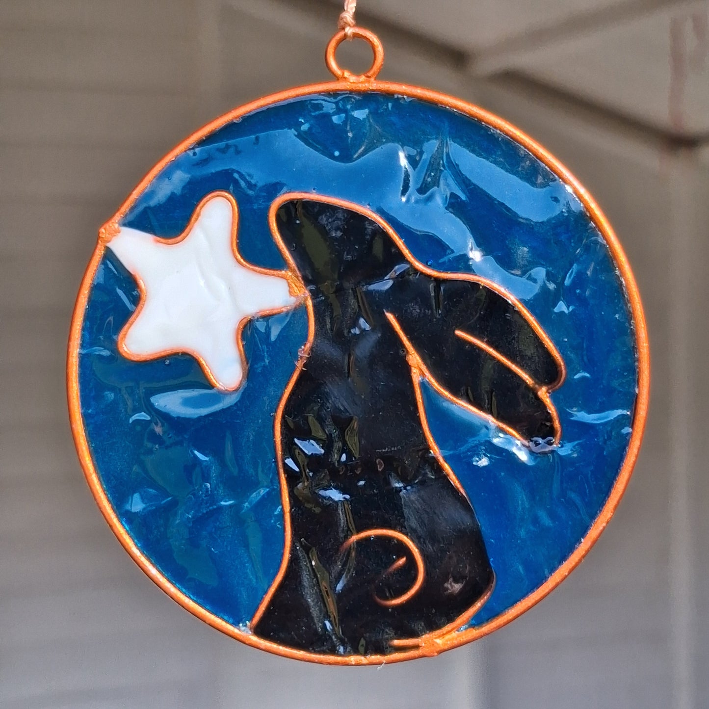 Invite the mystical energy of nature into the home with this little pagan suncatcher featuring a moon gazing hare and moon design. Handcrafted in Bali, this enchanting piece is sure to infuse any space with a touch of earthly charm.
