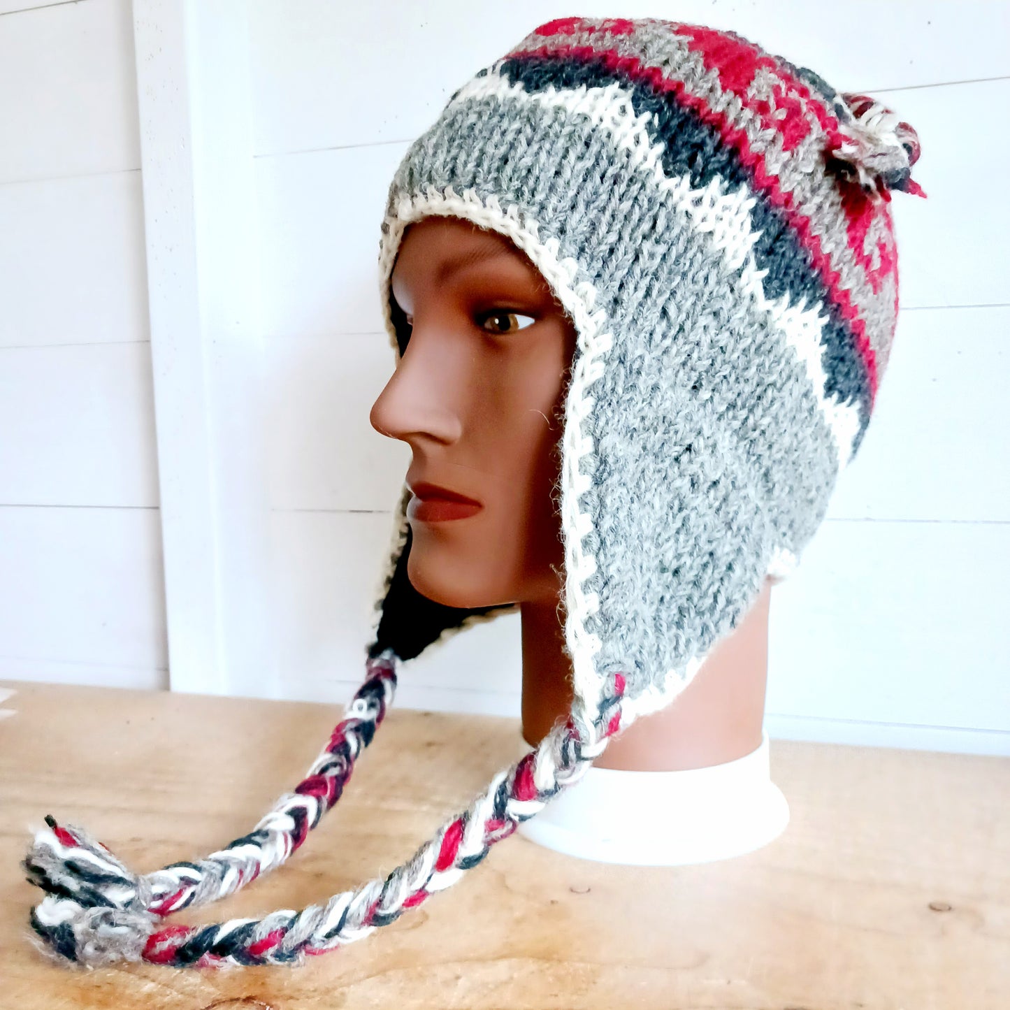 Stay cozy and stylish with our handmade chunky wool earflap hats, crafted in Nepal by skilled women artisans in Kathmandu. Each hat is 100% pure wool and features a soft polar fleece lining for extra warmth and comfort. Perfect for cold winter days, outdoor adventures, or adding a touch of handmade charm to your look.