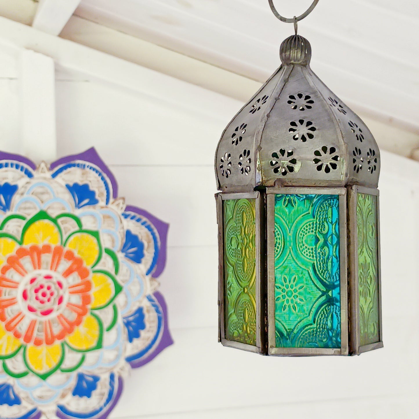 These small glass lanterns come in wonderful colours, featuring an intricate embossed pattern. They have a small hinged door that closes with a sliding catch. The small handle on the top is great for hanging the lanterns around your home. Perfect for adding a touch of warmth to your space.