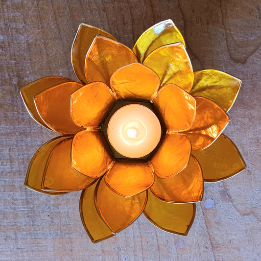 Illuminate your space with the peaceful elegance of our Capiz Shell Lotus Flower Candle Holder. Symbolizing enlightenment and serenity, this stunning handcrafted piece features delicate yellow petals edged in gold, forming the iconic lotus shape.