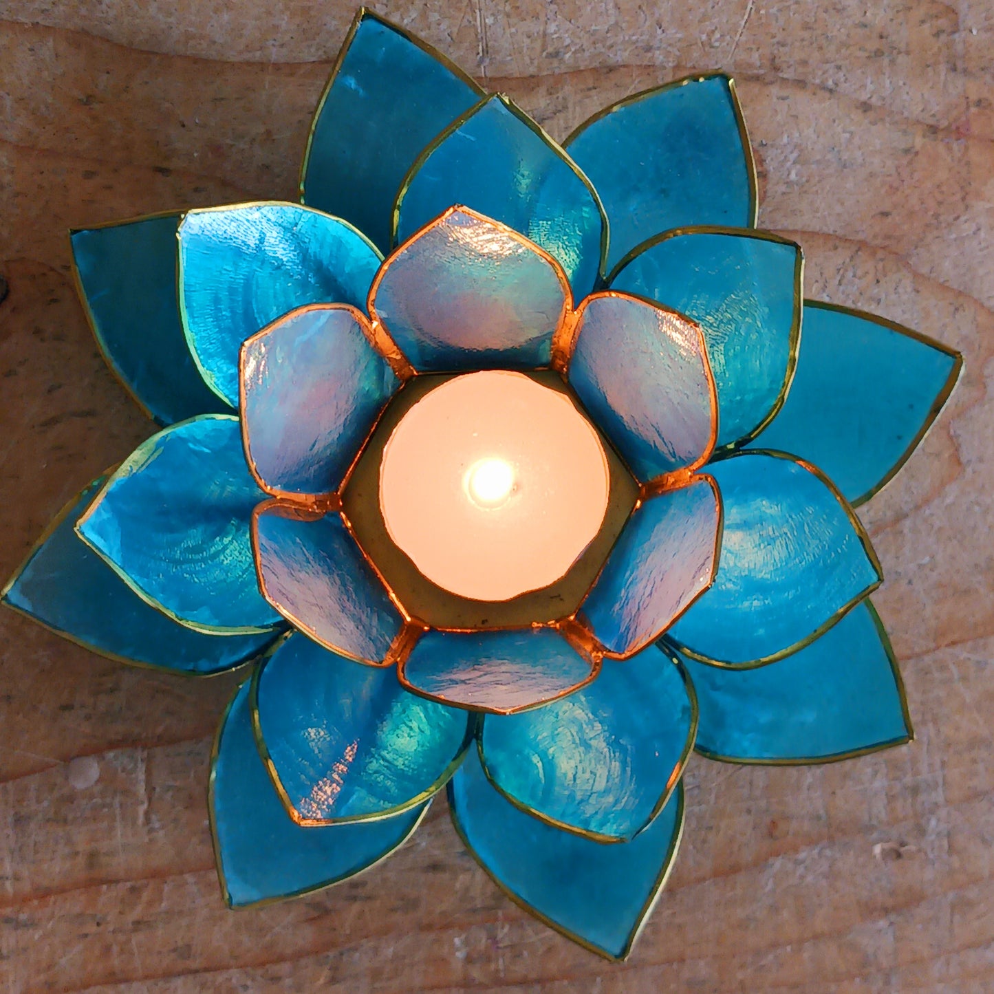 The Lotus Flower is a symbol of achieving enlightenment, peacefulness and spirituality. This beautiful candle holder can be fitted with tealight candles or slightly larger candles. The diameter of the middle is roughly 5.5cm, so it will fit any candle with the same diameter.