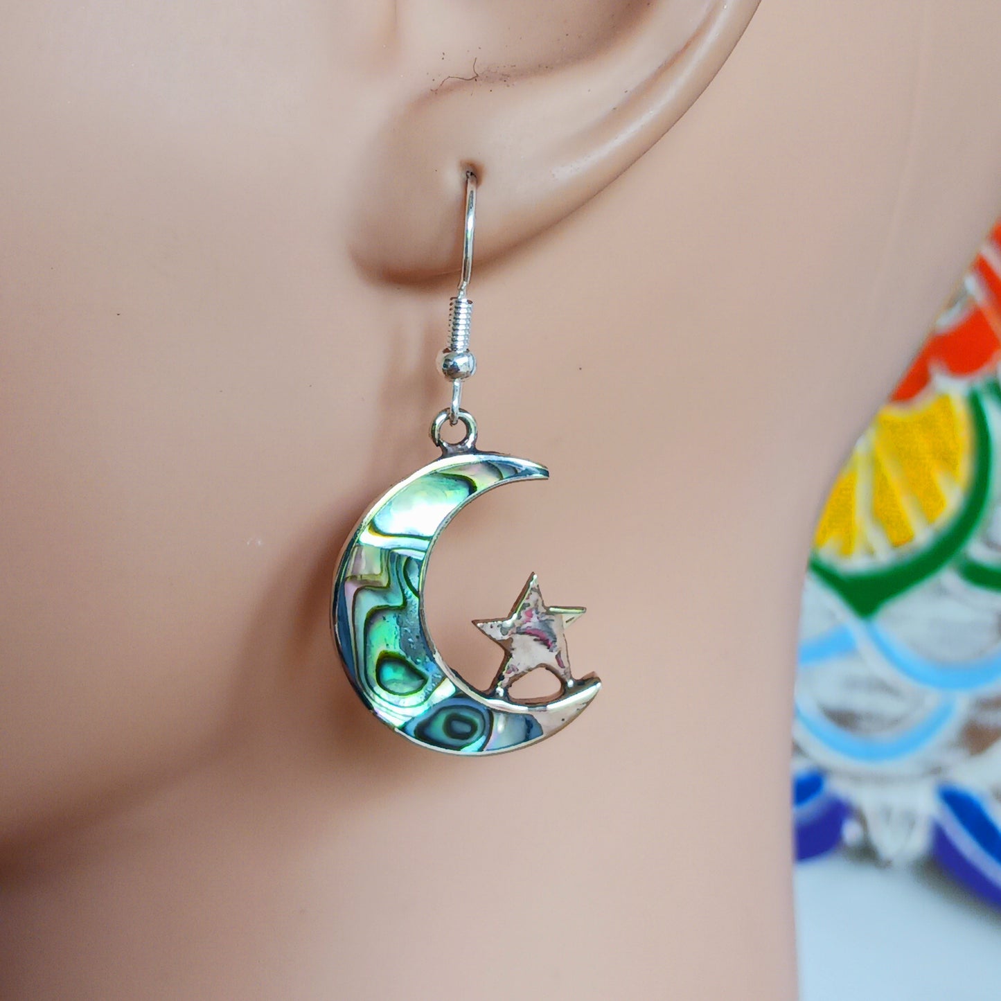 These stunning painted abalone earrings are beautifully crafted into a moon and stars shape. The fixing are silver plated. The earrings come in a recycled sari gift pouch.