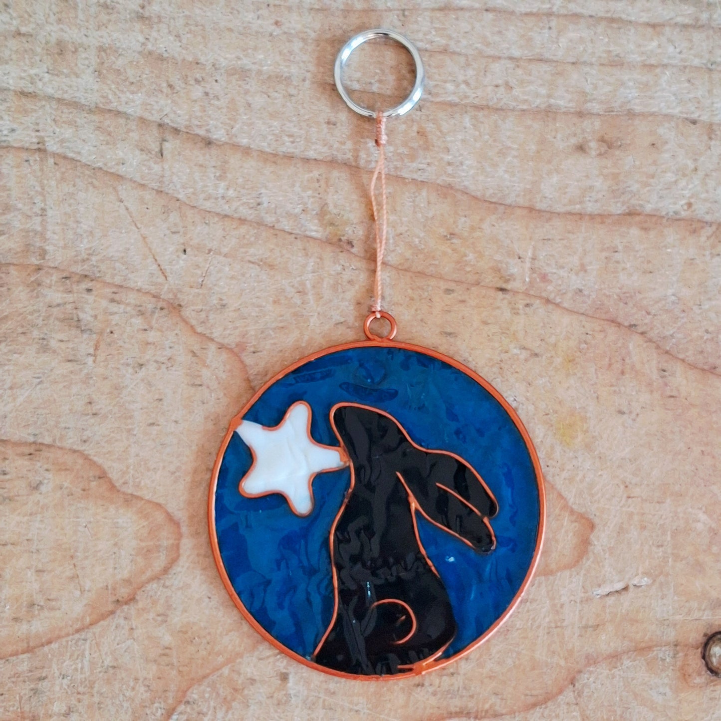 Invite the mystical energy of nature into the home with this little pagan suncatcher featuring a moon gazing hare and moon design. Handcrafted in Bali, this enchanting piece is sure to infuse any space with a touch of earthly charm.
