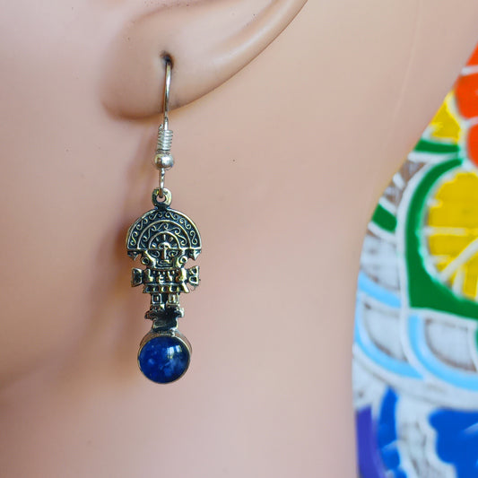 These intricate earrings feature a tiny image of the Tumi, a type of ceremonial knife used in ancient Peru by the Moche culture. They feature a mythical character usually identified with the god Naymlap.