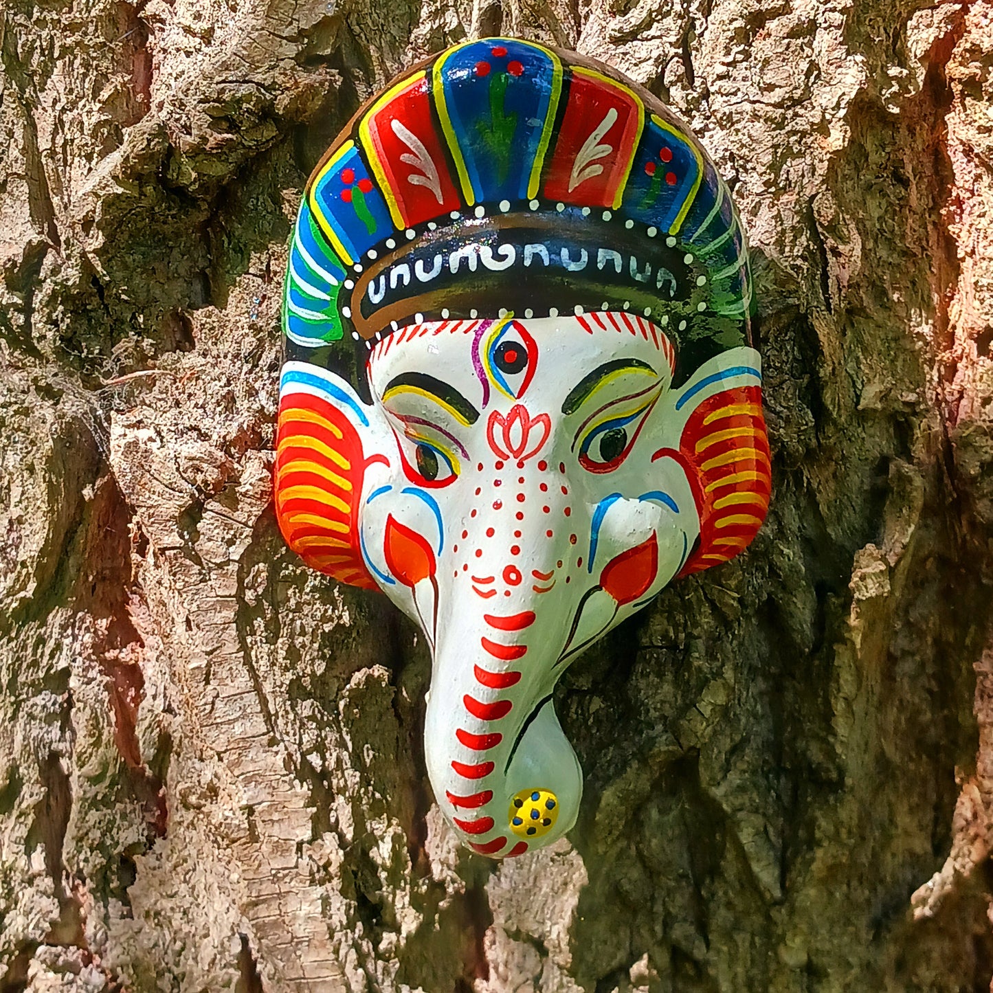 Bring the blessings of Ganesh into your home with this handcrafted terracotta mask from Nepal. Known as the remover of obstacles and the deity of wisdom, learning, and new beginnings, Ganesh is one of the most beloved figures in Hindu tradition. His elephant head and gentle features are beautifully captured in this spiritual wall hanging.
