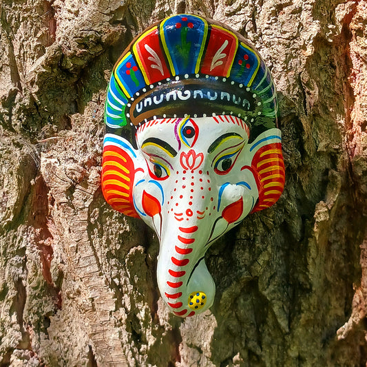 Bring the blessings of Ganesh into your home with this handcrafted terracotta mask from Nepal. Known as the remover of obstacles and the deity of wisdom, learning, and new beginnings, Ganesh is one of the most beloved figures in Hindu tradition. His elephant head and gentle features are beautifully captured in this spiritual wall hanging.