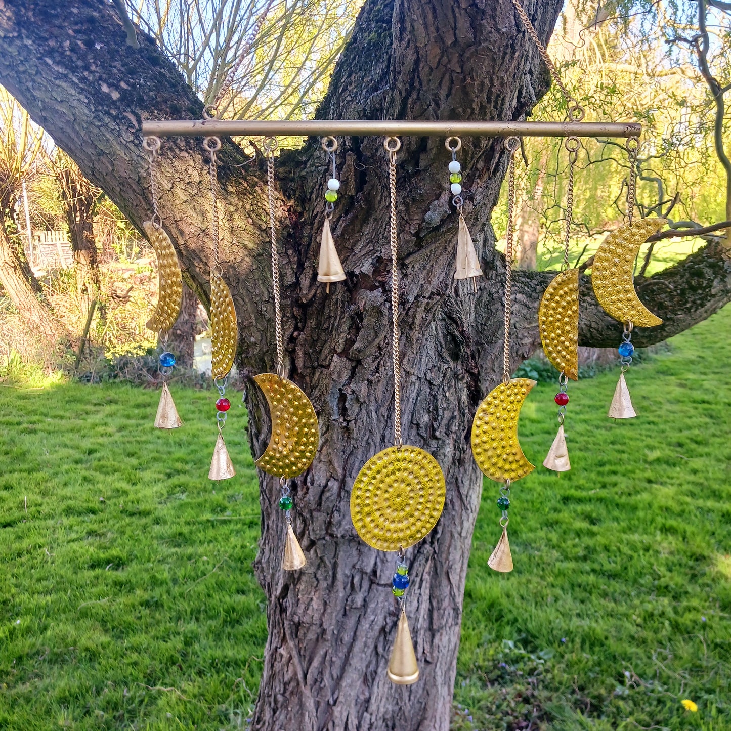 Add a little celestial beauty to your home with this unique brass Moon Phases Chimes. Made in India, it showcases the phases of the moon in stunningbrass, making it a striking piece for any space. Featuring intricate designs of each lunar phase, symbolizing the cycle of life and renewal.