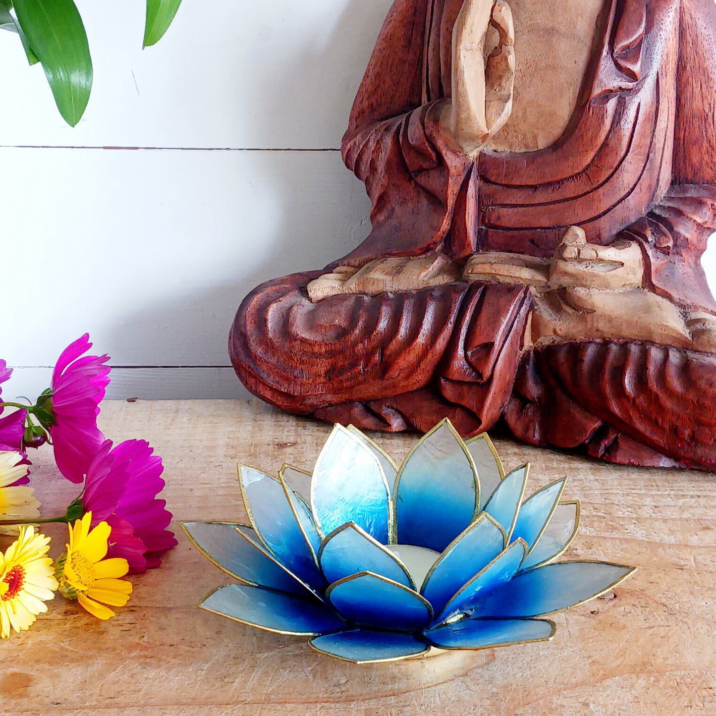 Illuminate your space with the peaceful elegance of our Capiz Shell Lotus Flower Candle Holder. Symbolizing enlightenment and serenity, this stunning handcrafted piece features delicate blue and white petals edged in silver, forming the iconic lotus shape. When lit, the layered design diffuses candlelight into a soft, radiant glow — ideal for creating a calming ambiance indoors or outdoors.