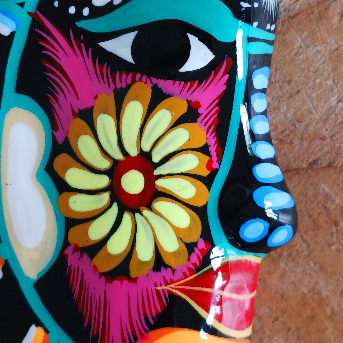 This vibrant wall plaque will have you over the moon! Expertly hand-painted in the bold, colorful style traditional to Xalitla in Guerrero, Mexico, this eye-catching piece celebrates the beauty of authentic Mexican folk art. A striking glaze enhances its vivid design, making it a stunning focal point in any room. The plaque includes two small holes for adding a hanging loop, allowing for easy wall display. Perfect for adding a splash of cultural charm to your home décor or gifting to lovers of artisan craft