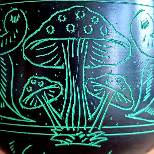 Bring a mystical and nature-inspired touch to your spiritual space with this beautifully crafted Black Aluminium Mushroom Singing Bowl. Handmade in India, this unique cauldron-style singing bowl features a striking black finish decorated with vivid green mushroom artwork, creating an eye-catching piece perfect for meditation rooms, altars, yoga studios, and bohemian interiors.