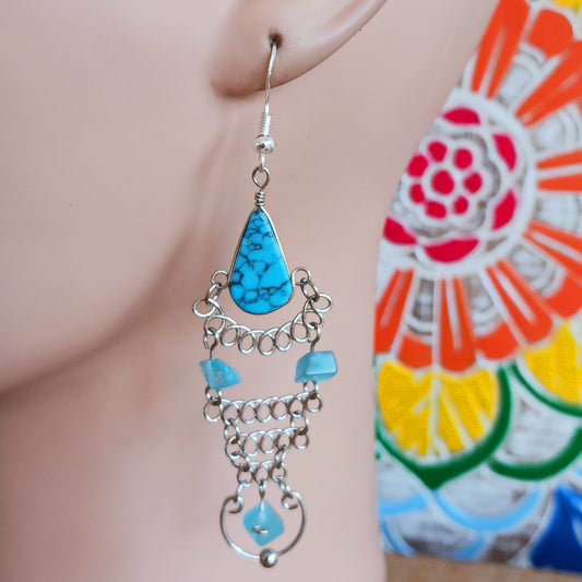 Add a touch of bohemian beauty to your look with these handmade Peruvian turquoise stone and beaded earrings. Featuring turquoise stones and finished with silver-plated hooks, each pair is carefully crafted in small workshops in Peru.