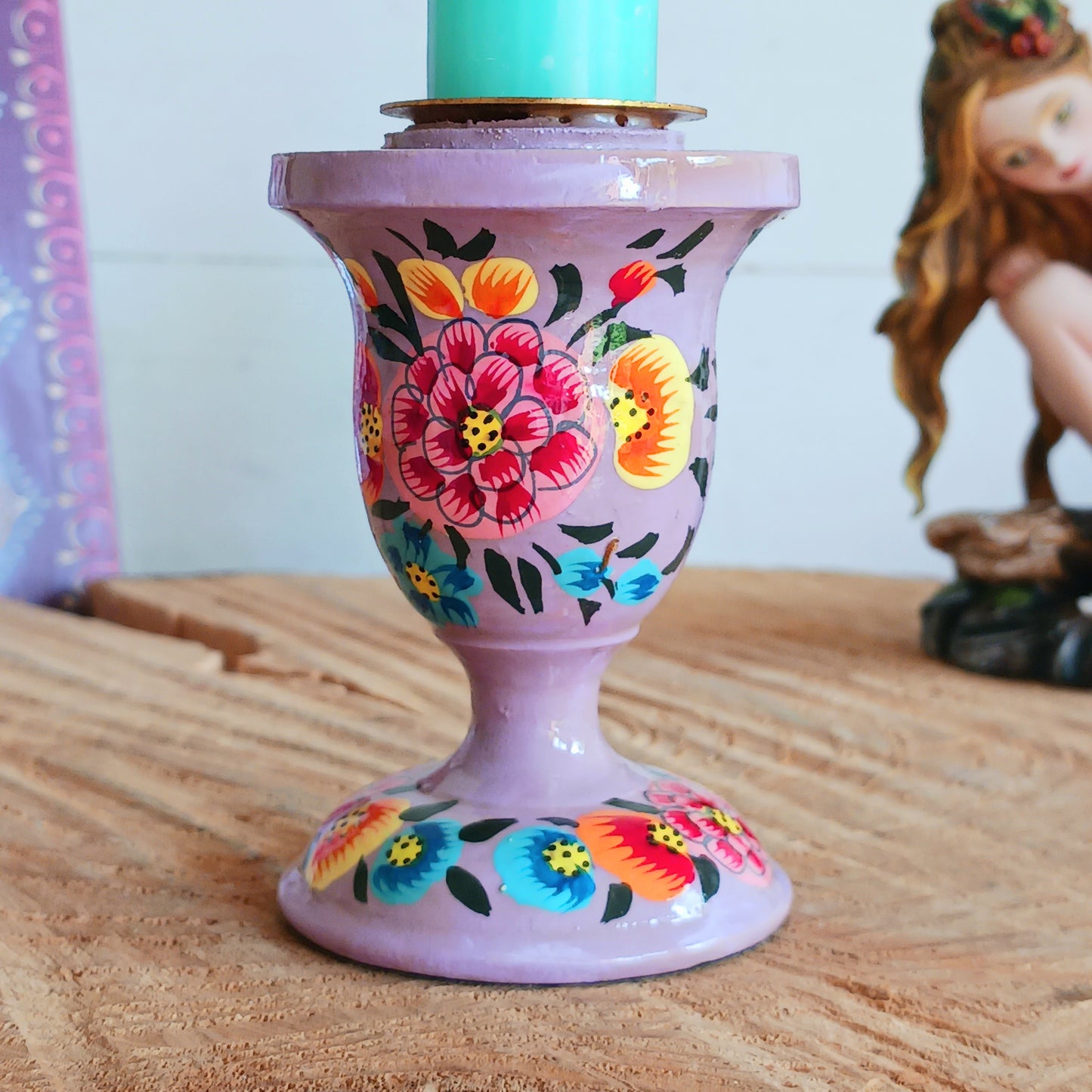 Enhance your home with these beautifully handmade decorative candle holders, crafted from sustainable willow wood. Each piece is meticulously hand-painted with intricate flower petal motifs and delicate foliage, completed with a high-shine glaze to intensify the elegant design.