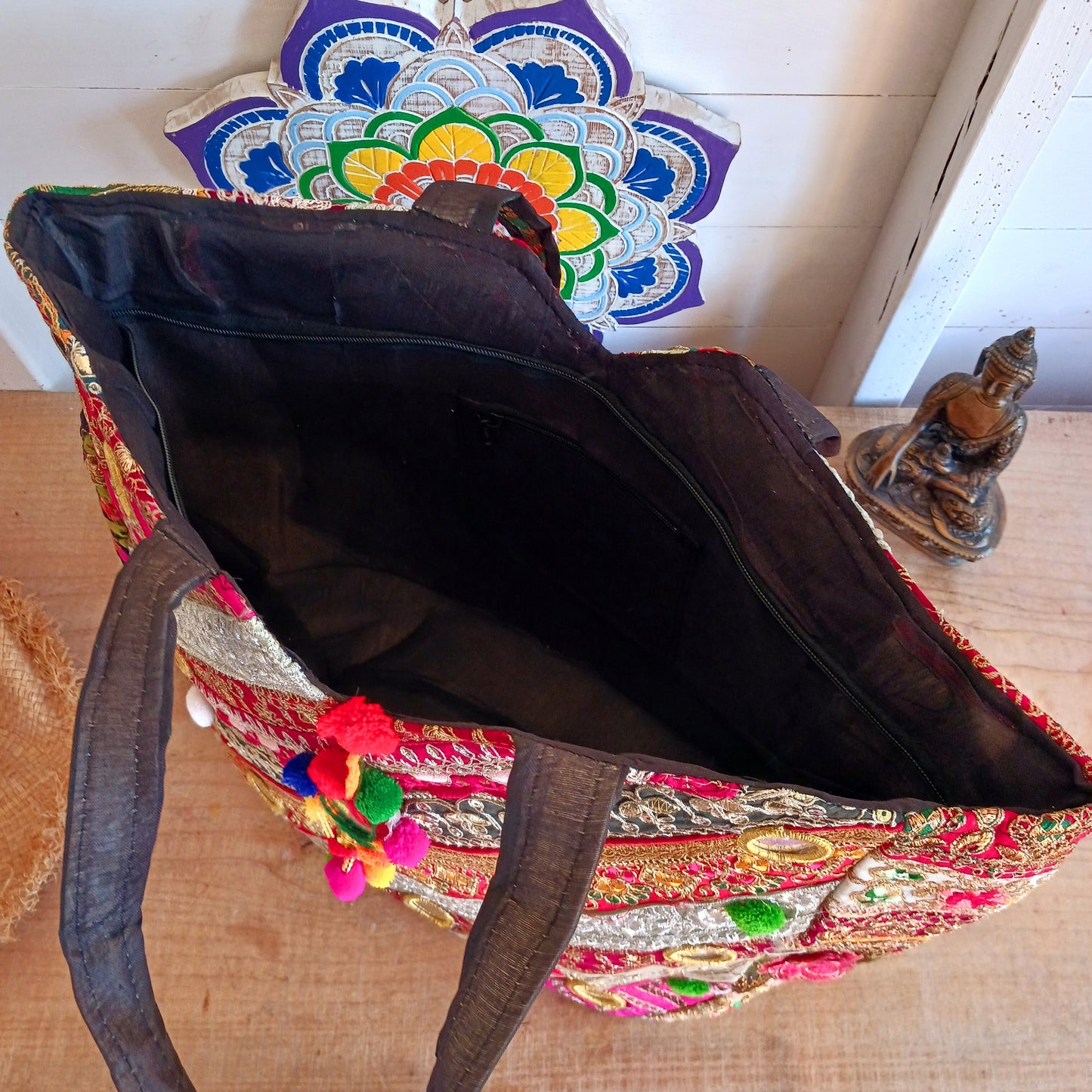 This beautiful large Indian bag comes with a wide shoulder strap and plenty of space inside for your personal items. In a patchwork style design, this bag is intricately embroidered with a traditional bohemian pattern. The bag is fully lined throughout.