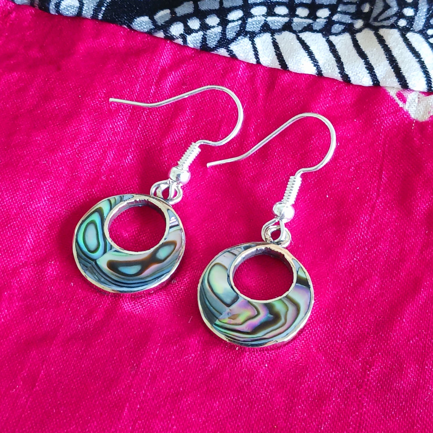 Rock the 'jefa' ('girl boss') look with these small but stylish hoop earrings crafted from iridescent abalone shell.