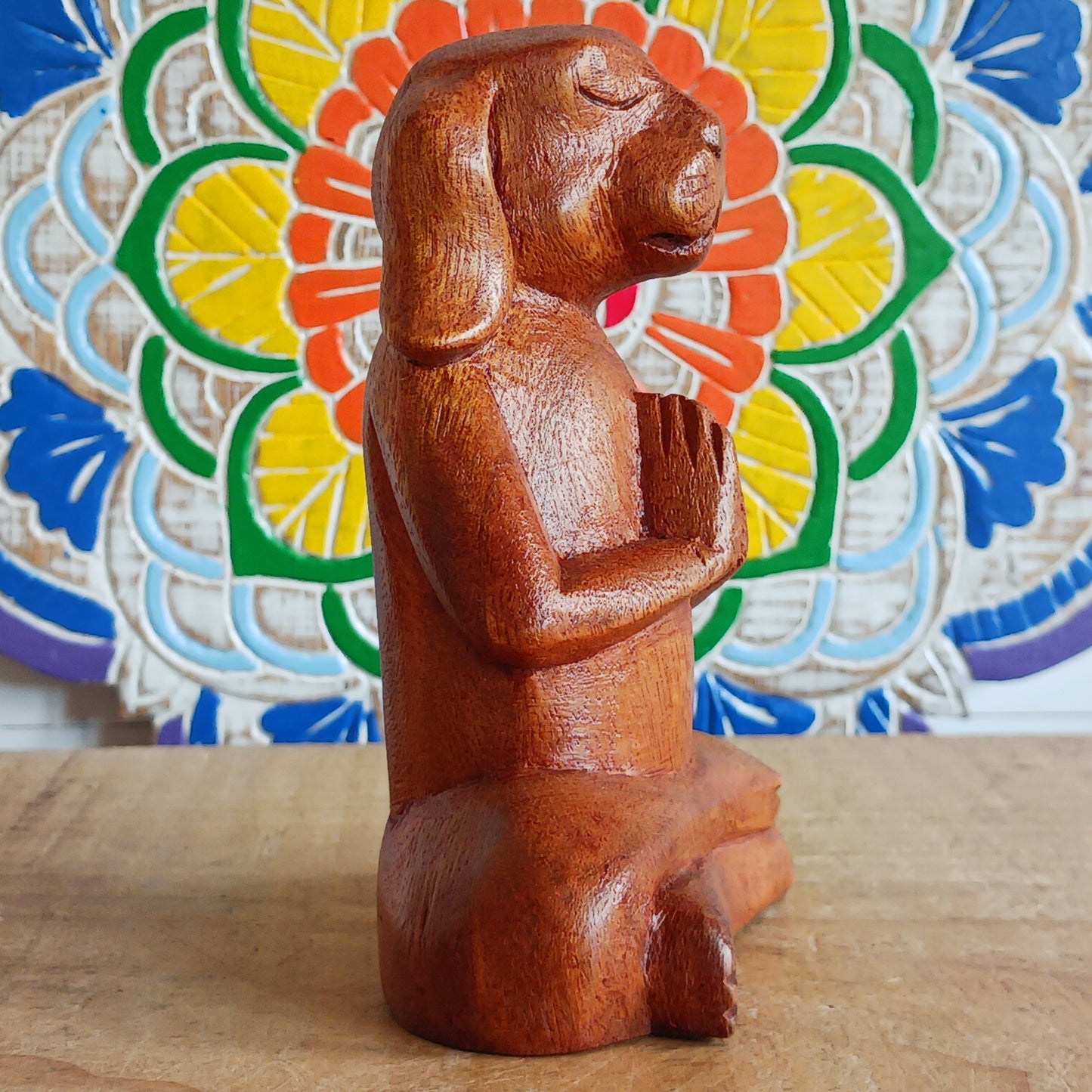 Add a touch of playful serenity to your space with this Meditating Dog Woodcarving. With its paws pressed together in prayer and eyes gently closed, this charming figure radiates calm and quiet joy. Perfect for yoga studios, meditation corners, or any space that could use a little extra soul, it brings a relaxed, earthy energy into your home.