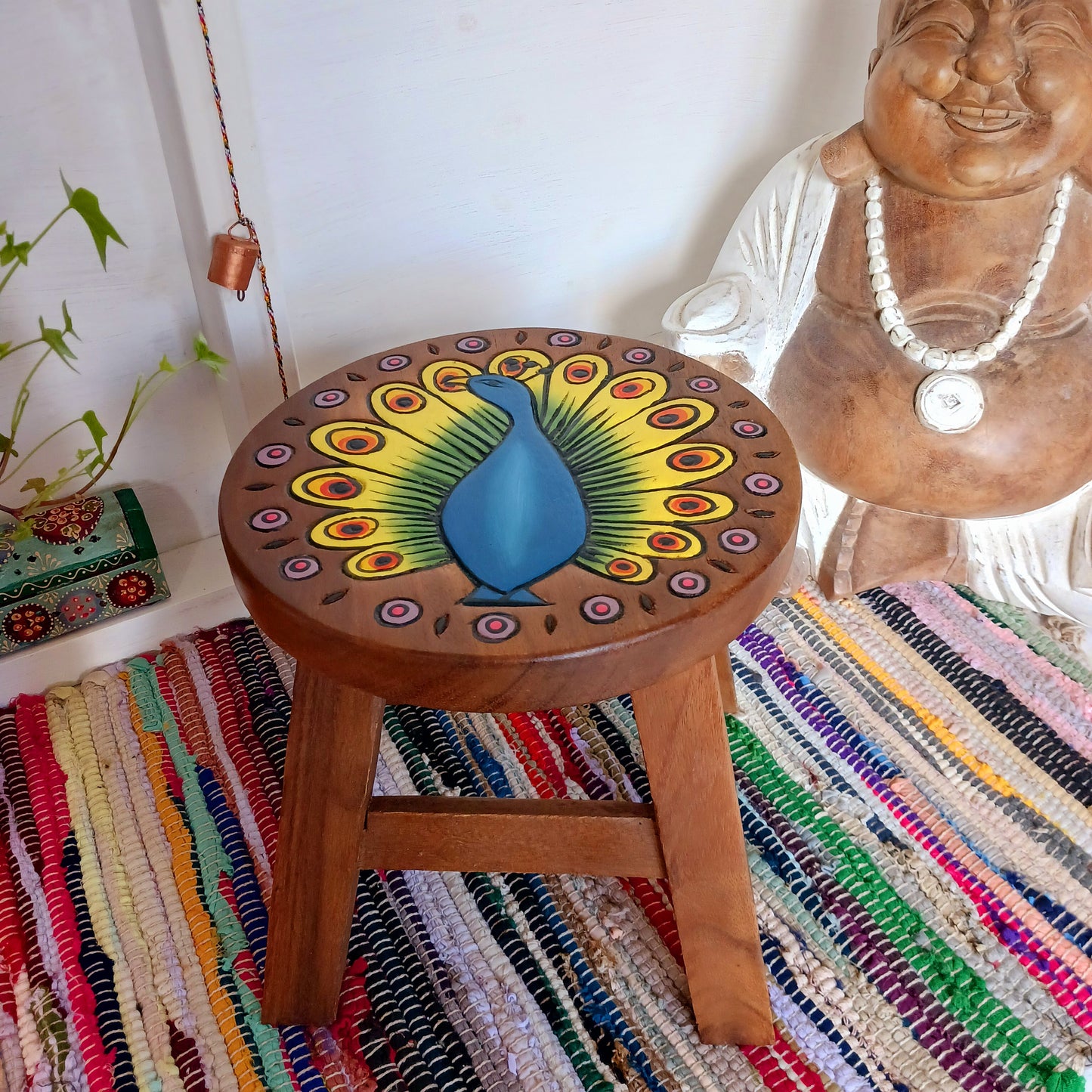This lovely handmade, carved and painted stool is Fairtrade from Thailand. The top of this stool has been carefully hand carved and then painted to show a radiantly beautiful peacock, displaying his wonderful plumage. These cheeky little items are very versatile making great stools for little bums or as tiny tables to add accent to your home.